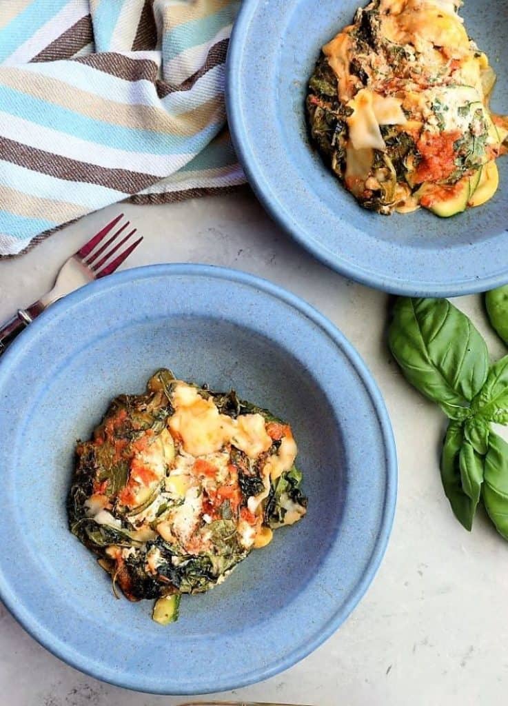 two servings of Zucchini Kale Lasagna on blue plates
