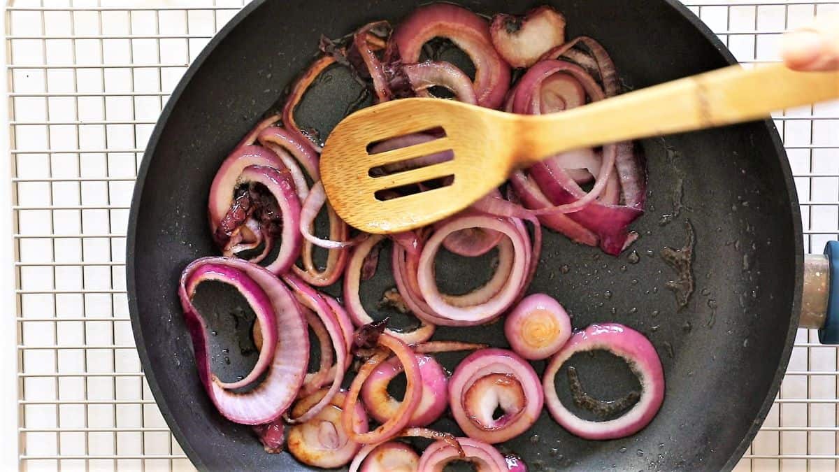 Add red onion, maple syrup, coconut oil and salt to pan and saute