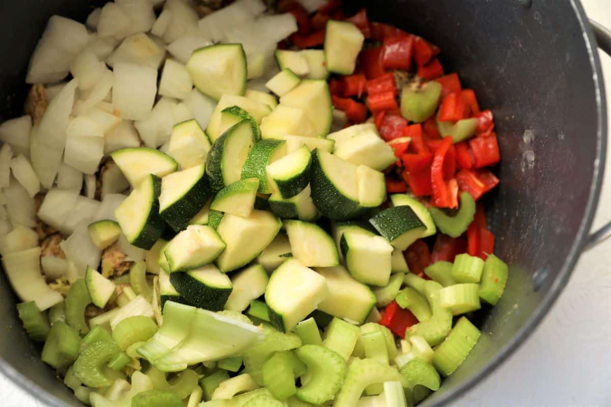 Add vegetables and oil to large soup pot and saute