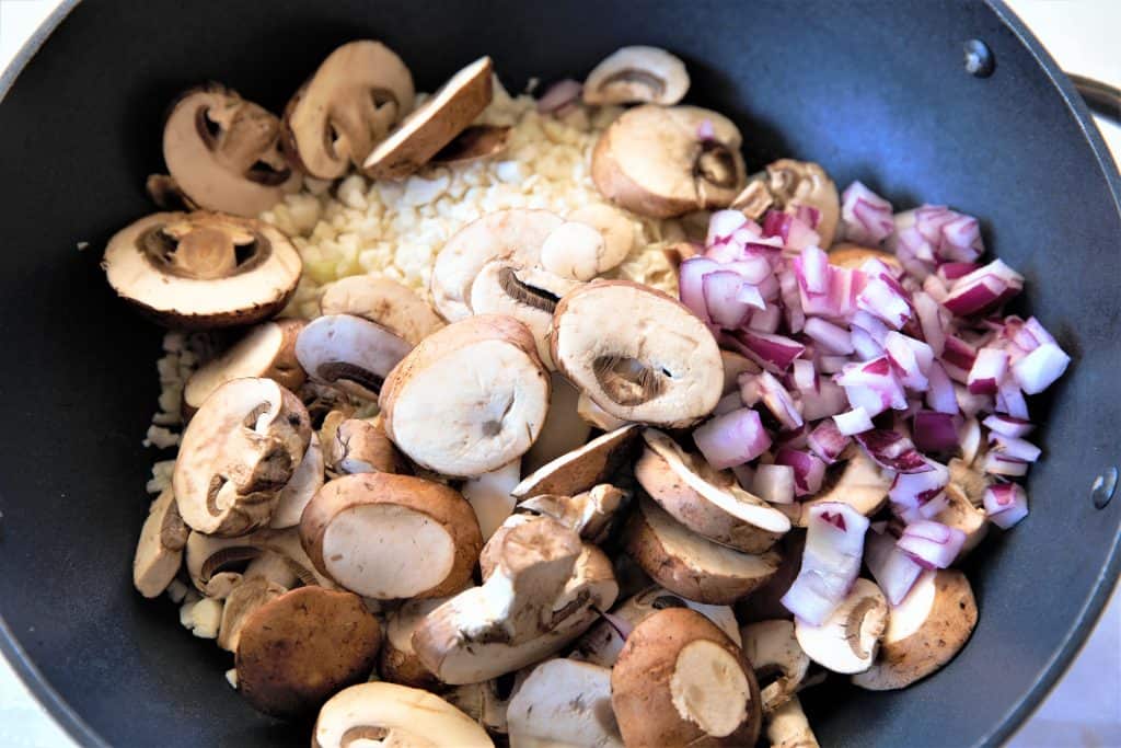 Add oil, onion, mushrooms and cauliflower to pan. Stirfry.