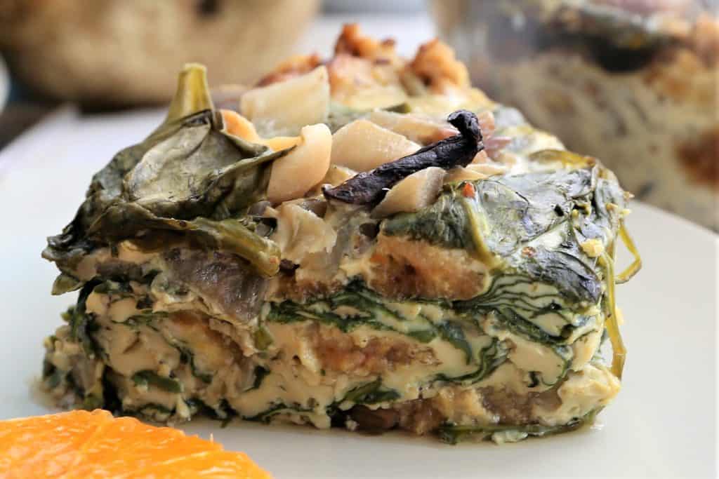 single serving of spinach potato mushroom breakfast casserole on a white plate
