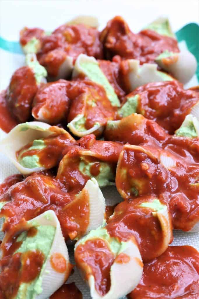 Pour marinara sauce over stuffed shells