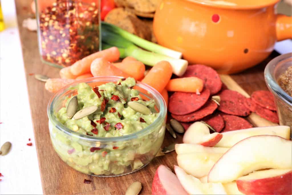 Jalapeno Guacamole in a small glass bowl on the vegan dip and veggie platter