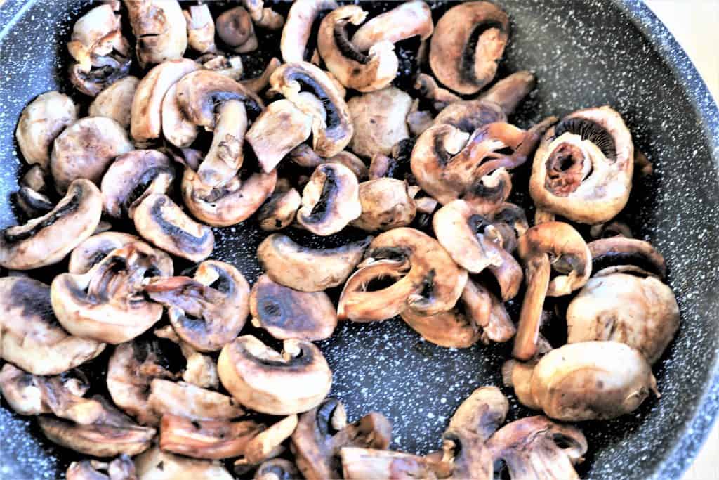 mushrooms sautéing in a pan