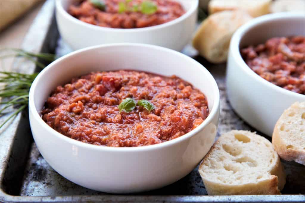 Serve chili with bread and top with herbs