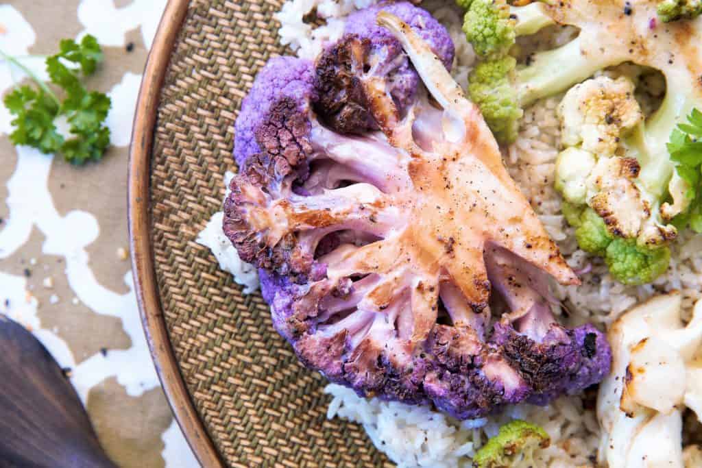 Grilled purple cauliflower on bed of rice