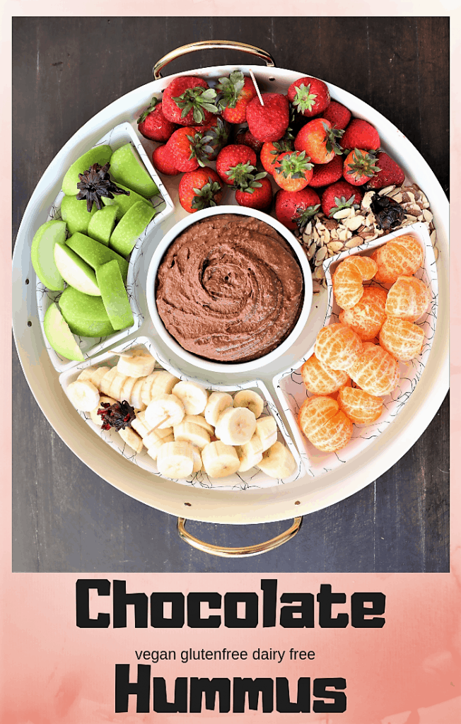 chocolate hummus in a serving platter with strawberries, apples, bananas, and mandarin oranges