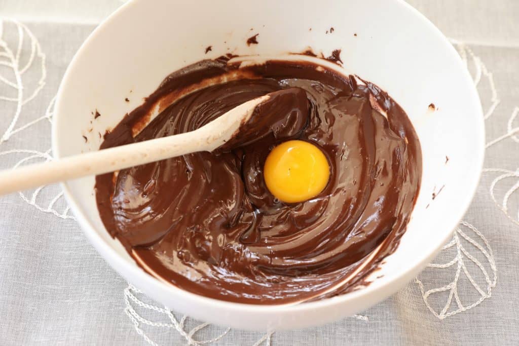 Melt chocolate in microwave. Add egg yolks, one at a time