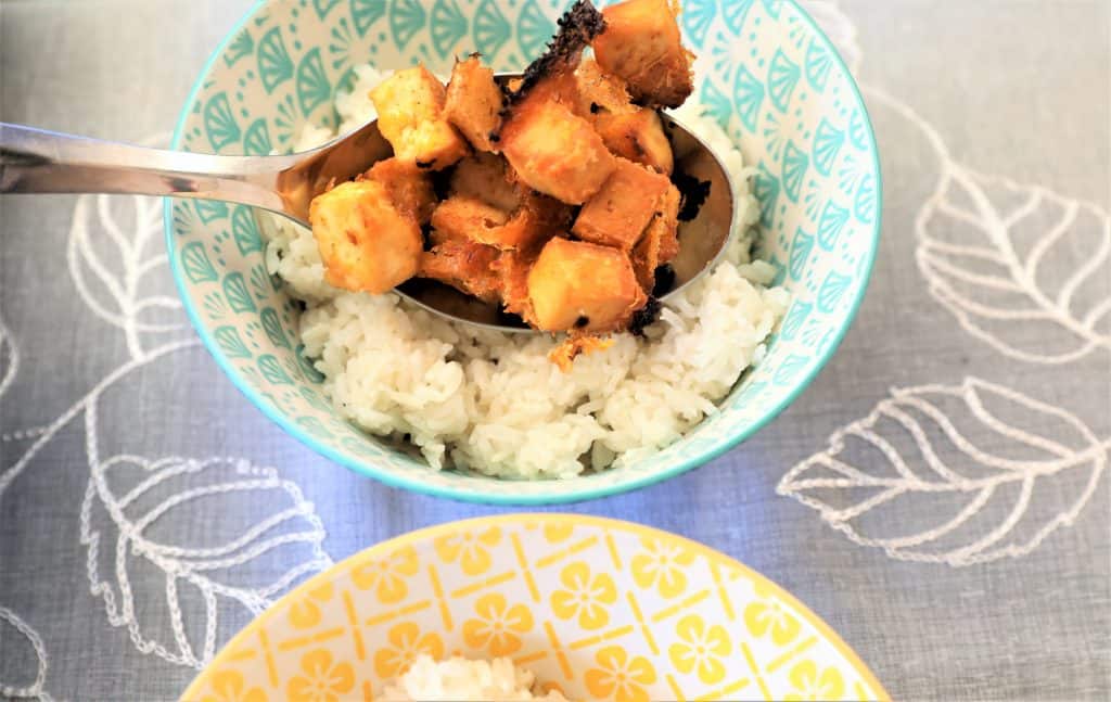 Spoon tofu onto rice