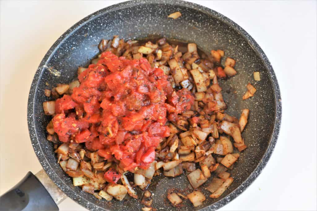 add tomatoes and vegetable broth to pan