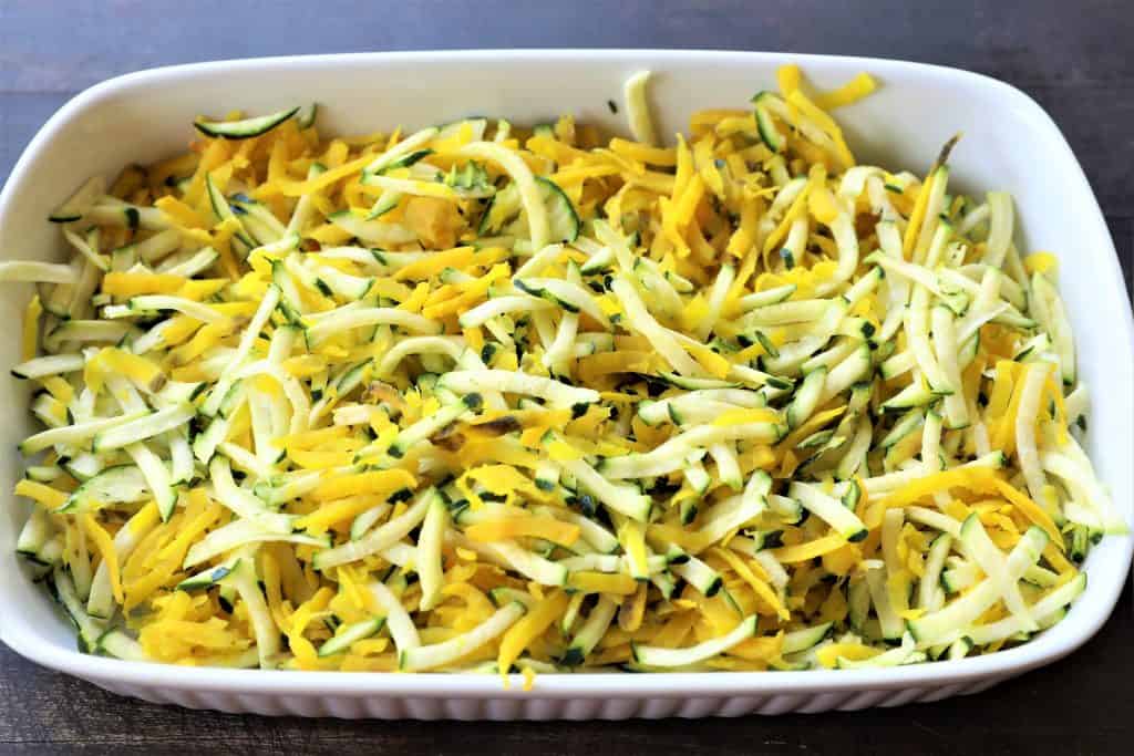 Add shredded golden beets and zucchini to bowl and mix well