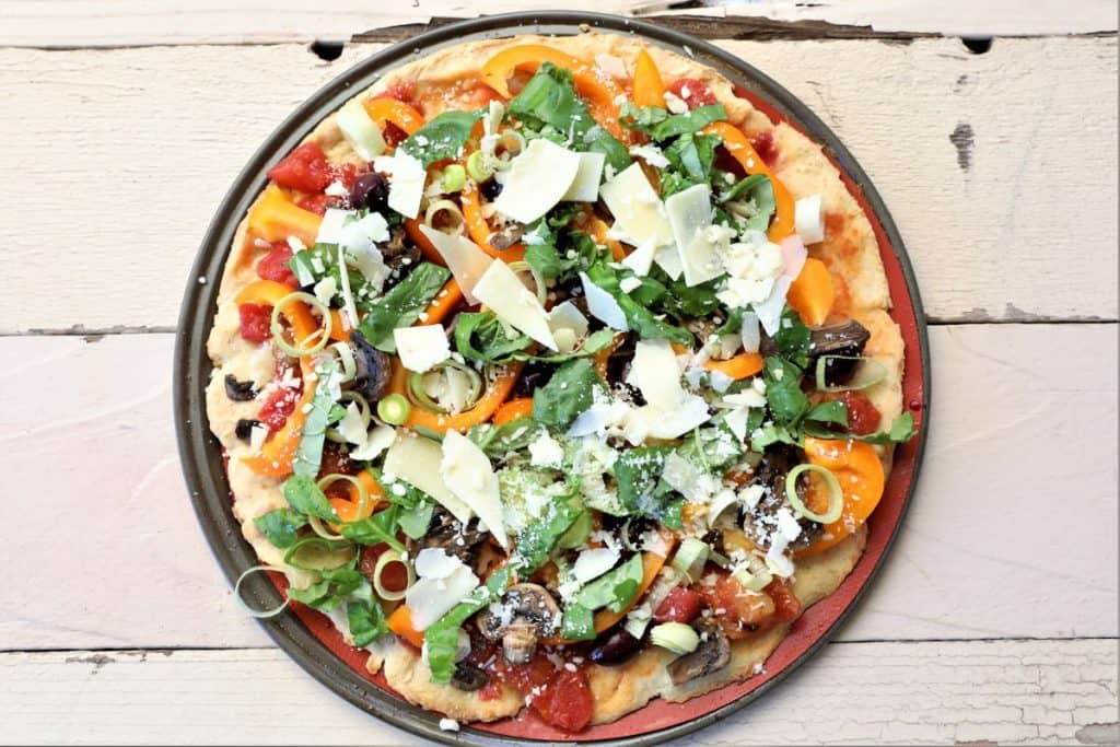 cauliflower quinoa pizza on a wooden table 