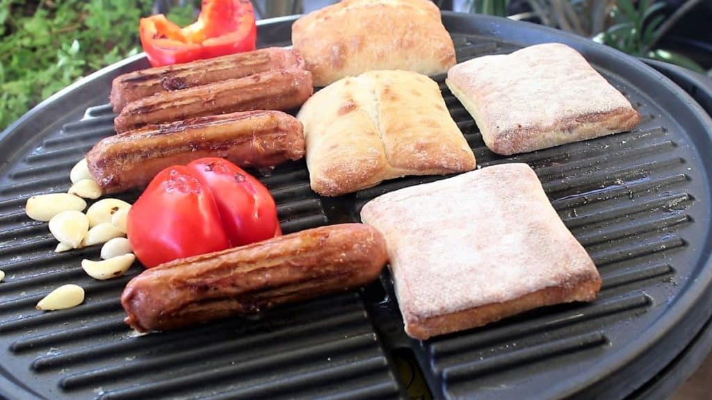 Grill sausage, pepper, garlic and toast ciabatta rolls
