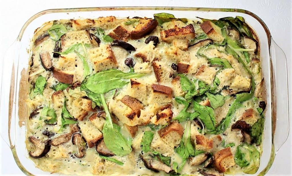overhead photo of cooked spinach potato mushroom breakfast casserole in a 9 by 13 dish.