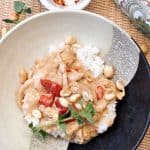 Bowl of Spicy Peanut Chicken with herbs