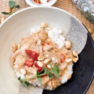 Bowl of Spicy Peanut Chicken with herbs