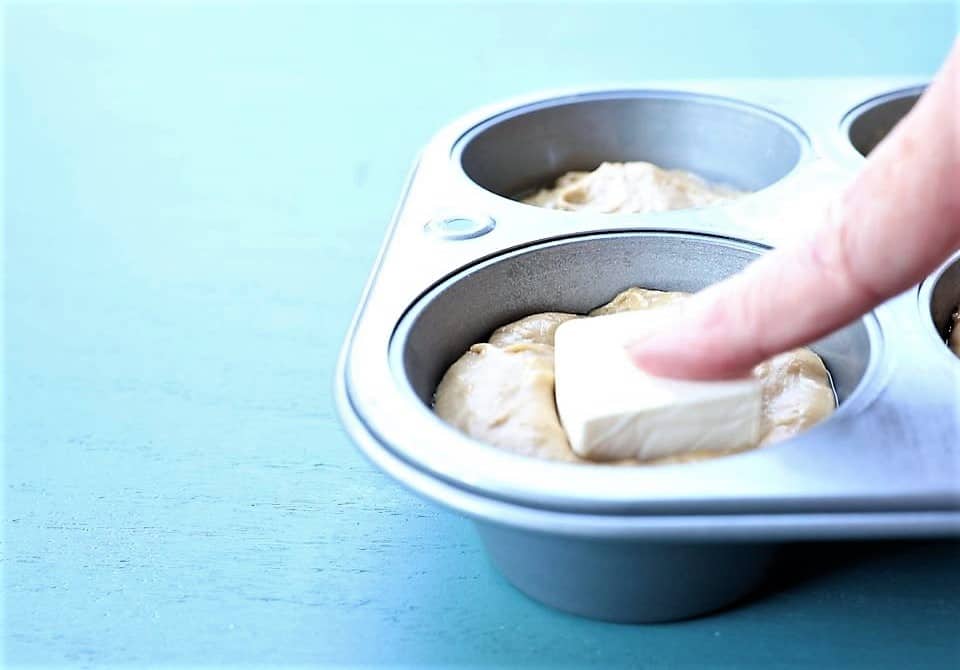 Press cube of cream cheese into middle of muffin batter