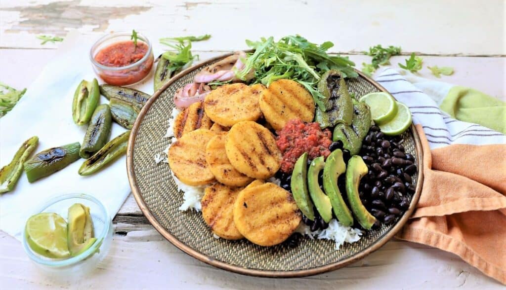 Grilled Polenta Bowl completed with lime, jalapenos, salsa