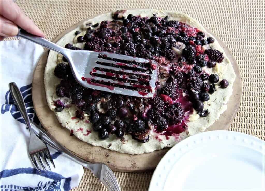 Press down on berries with spatula